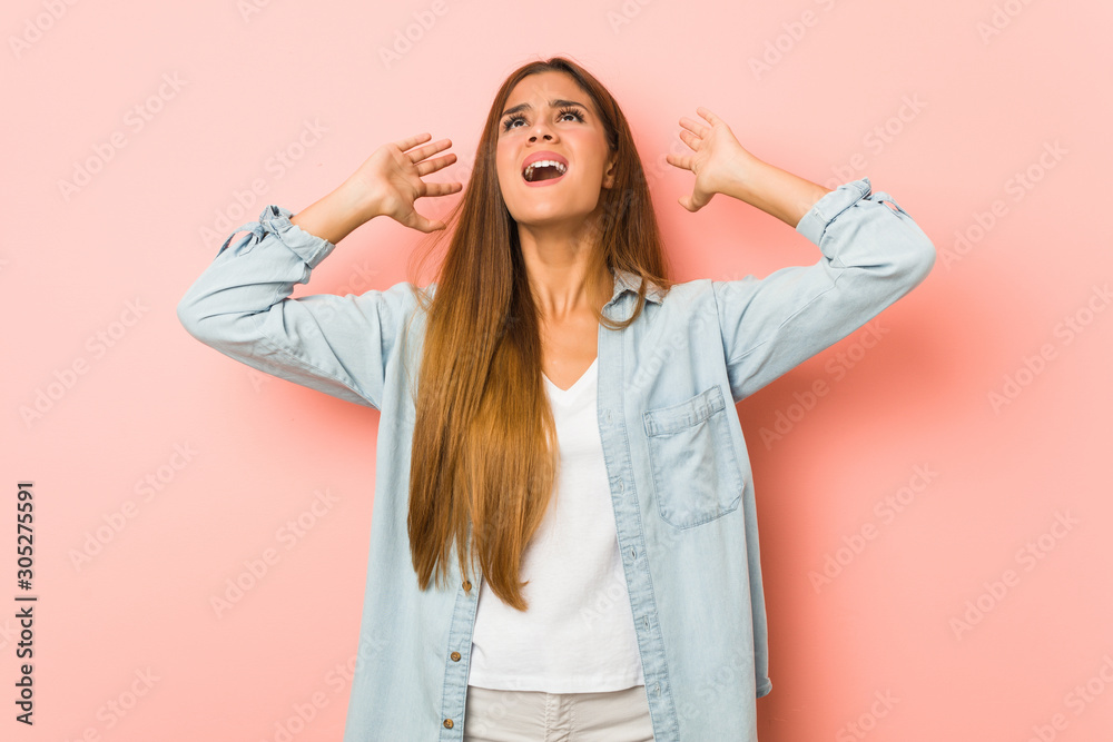 Young slim woman screaming to the sky, looking up, frustrated. Young slim woman screaming to the sky, looking up, frustrated.