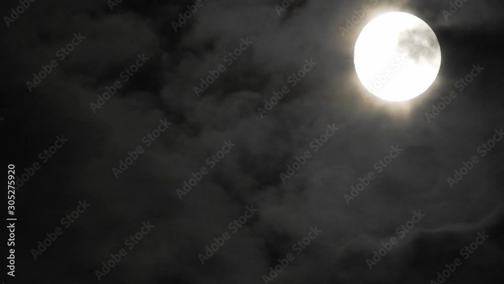 Full moon at night with cloud real time. 4k video full moon in the black sky. Clouds passing by moon at night. night sky with cloudy weather Full moon at night with cloud real time. 4k video full moon in the black sky. Clouds passing by moon at night. night sky with cloudy weather