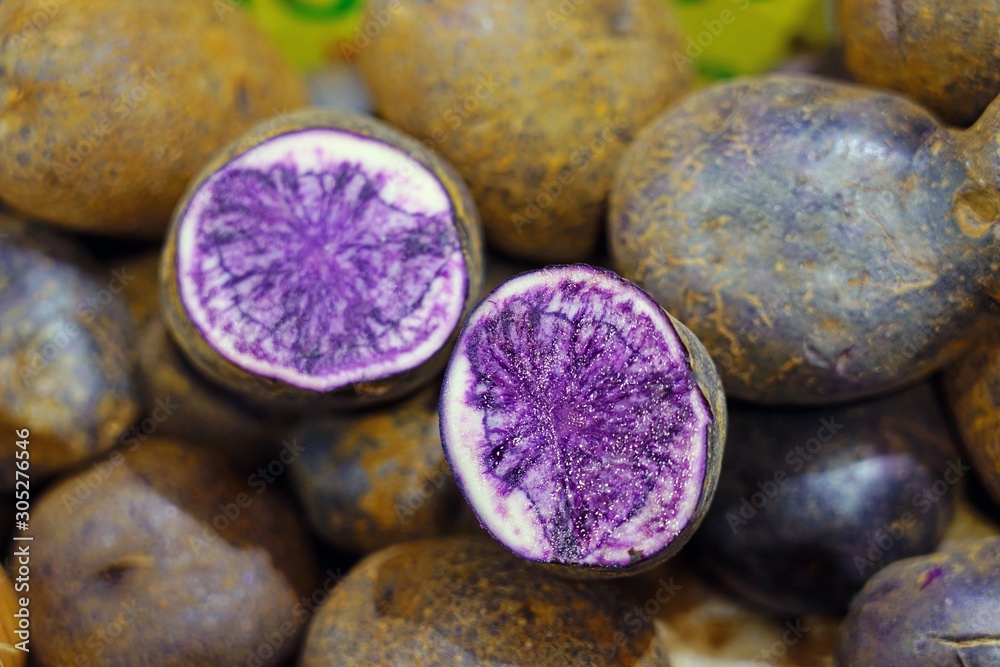 Purple potatoes in bulk at the farmers market Purple potatoes in bulk at the farmers market