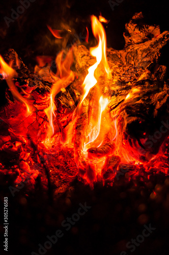 Bright orange-red flames of night fire. Close-up.