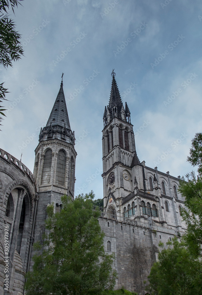 View of the basilica buildings above the Massabielle grotto at the Marian Shrine in Lourdes,