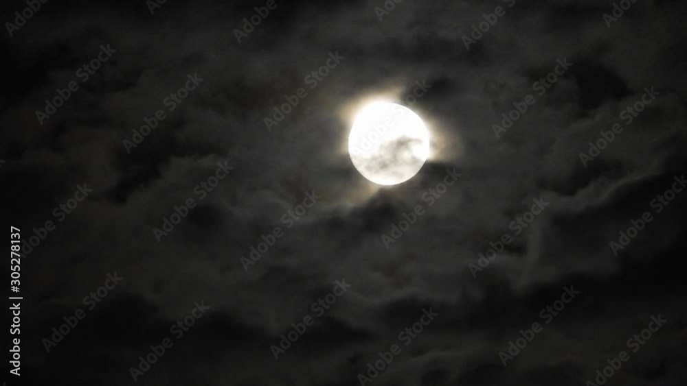Full moon at night with cloud real time. 4k video full moon in the black sky. Clouds passing by moon at night. night sky with cloudy weather Full moon at night with cloud real time. 4k video full moon in the black sky. Clouds passing by moon at night. night sky with cloudy weather
