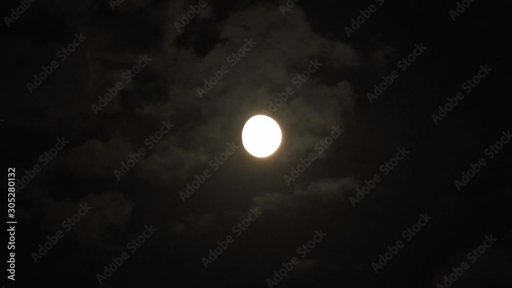 Full moon at night with cloud real time. 4k video full moon in the black sky. Clouds passing by moon at night. night sky with cloudy weather Full moon at night with cloud real time. 4k video full moon in the black sky. Clouds passing by moon at night. night sky with cloudy weather