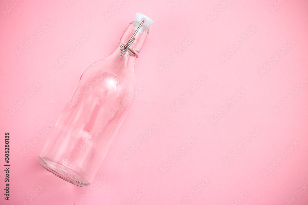 Reusable bottle on pink background. Glass bottle. Copy space. Retro Reusable bottle on pink background. Glass bottle. Copy space. Retro