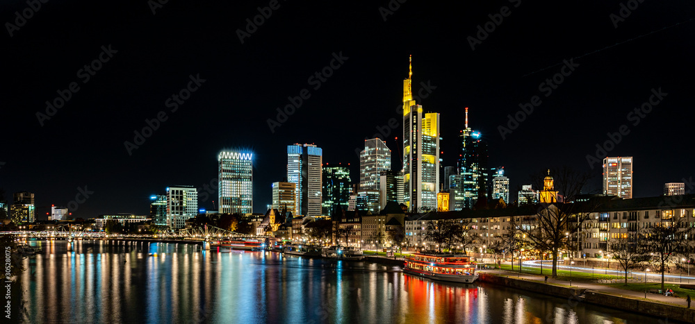 frankfurt skyline at night with colorful reflections in the main river, frankfurt am main, germany frankfurt skyline at night with colorful reflections in the main river, frankfurt am main, germany