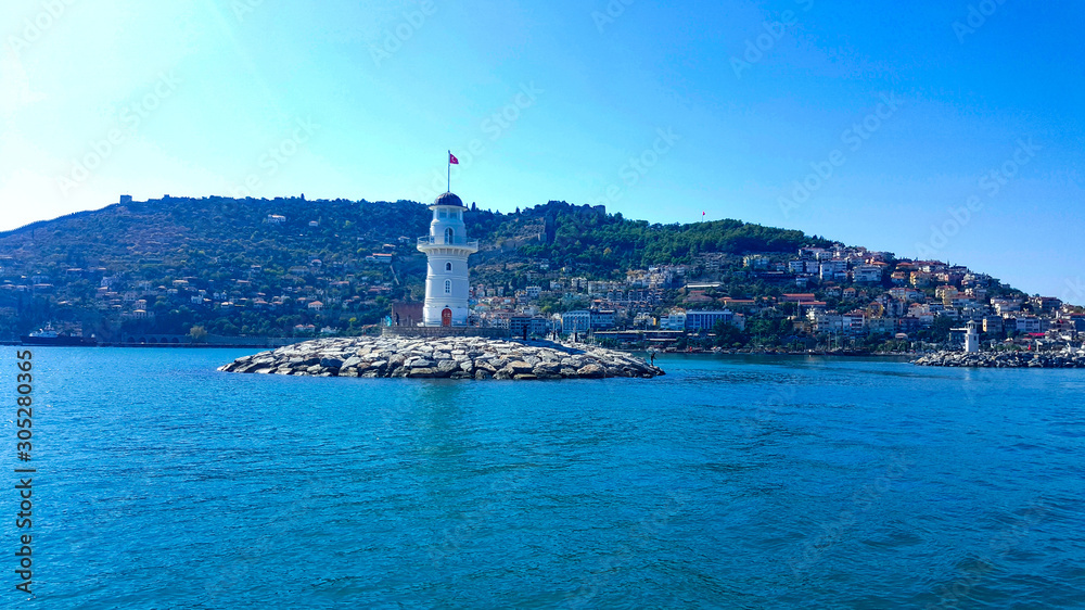 Lighthouse in the port of Alanya. Sea view of the lighthouse in Alanya Turkey. Lighthouse in the port of Alanya. Sea view of the lighthouse in Alanya Turkey.