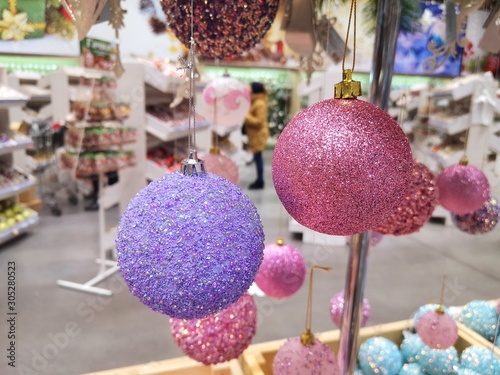 Purple Christmas balls on the artificial fir. Christmas concept  lovely decorated Christmas tree. Shiny decoration balls. New year decoration. New year tree decorated with sparkles colorful balls