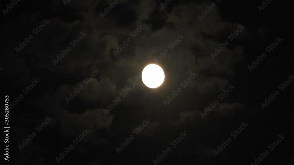 Full moon at night with cloud real time. 4k video full moon in the black sky. Clouds passing by moon at night. night sky with cloudy weather Full moon at night with cloud real time. 4k video full moon in the black sky. Clouds passing by moon at night. night sky with cloudy weather