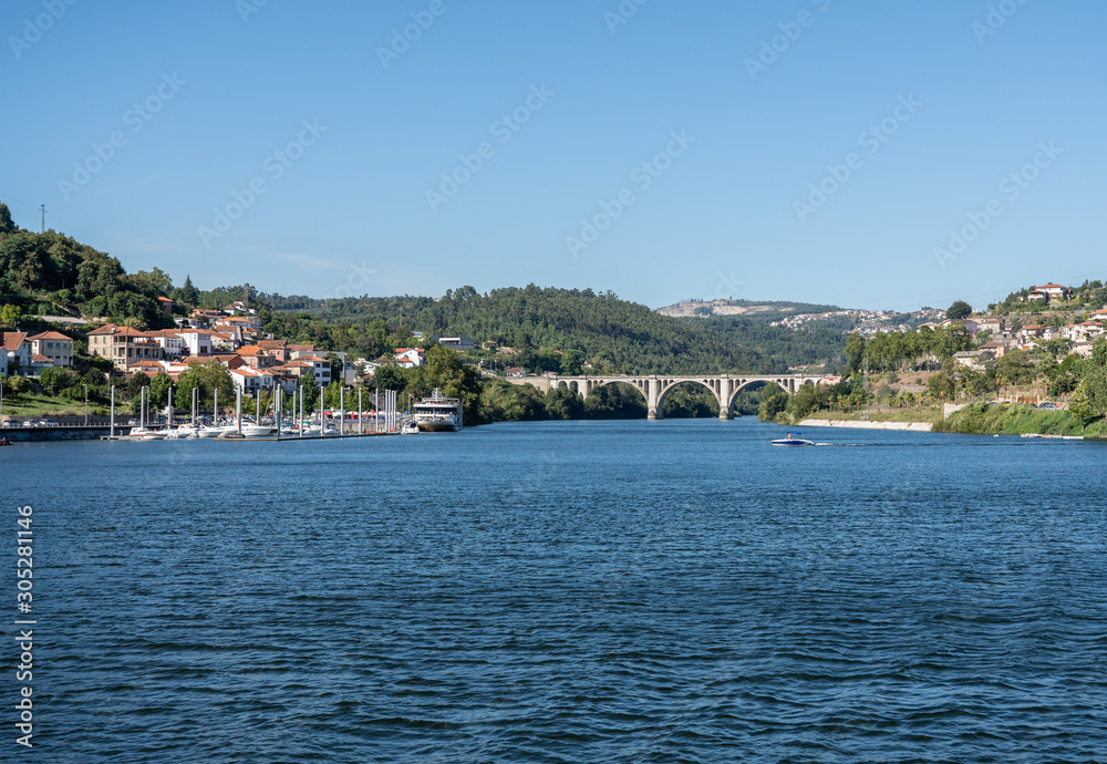 Small marina with power boats and docked river cruise boat in the Douro valley near Porto