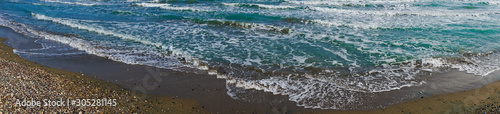 Panoramic shot of foamy wavy sea.
