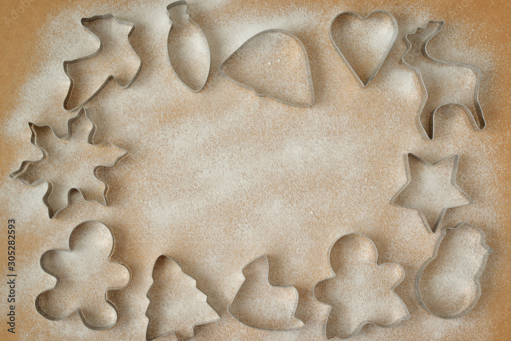cookie cutters and cookies not a wooden background with icing sugar