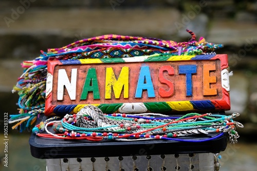  A plate with the colorful inscription "namaste", which means "good morning" in Nepali, on a souvenir market with handicrafts