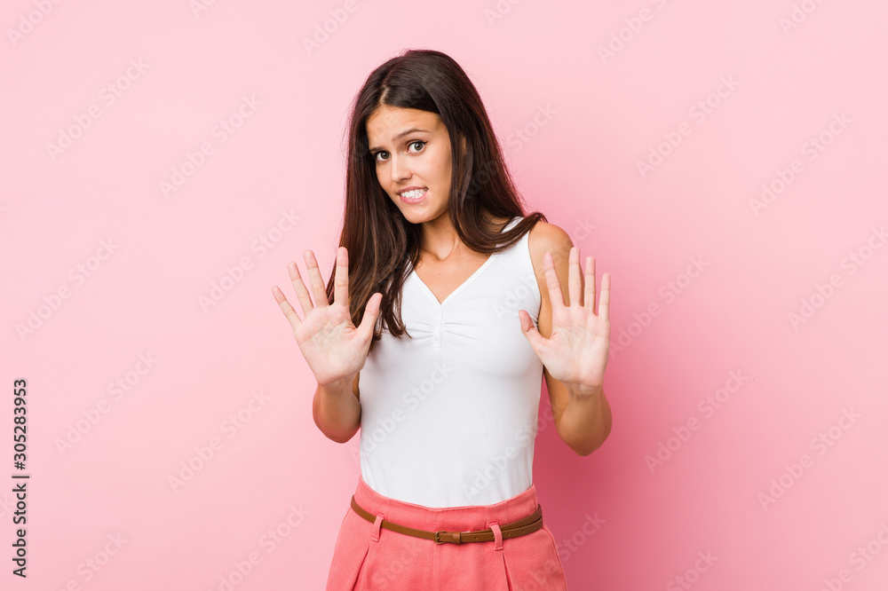 Young cute woman rejecting someone showing a gesture of disgust. Young cute woman rejecting someone showing a gesture of disgust.