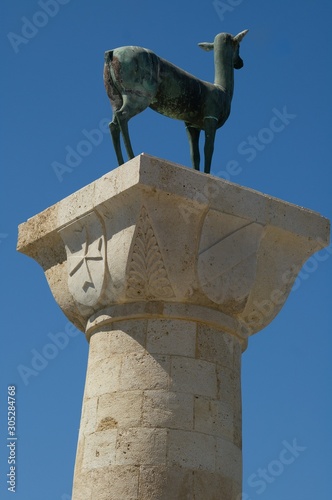 Statue in the place of the Colossus of Rhodes at the entrance from inner embankment in the Mandraki old harbour of the City of Rhodes, Greek Dodecanese