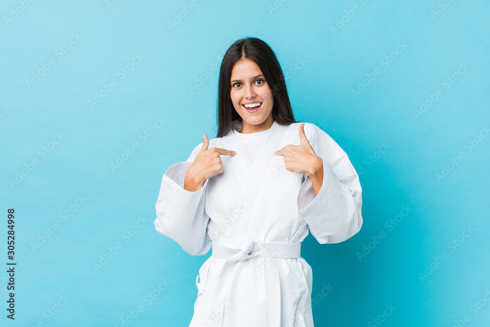 Young karate woman surprised pointing at himself, smiling broadly. Young karate woman surprised pointing at himself, smiling broadly.