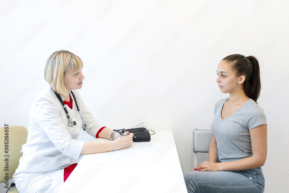 Physiotherapist. Young girl examined by a physiotherapist in a medical clinic Physiotherapist. Young girl examined by a physiotherapist in a medical clinic