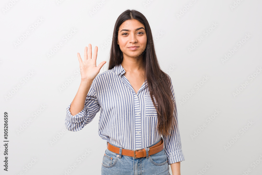Young pretty arab woman smiling cheerful showing number five with fingers. Young pretty arab woman smiling cheerful showing number five with fingers.