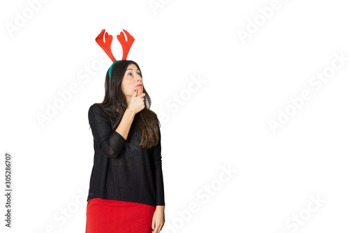 Young pretty woman wearing funny red horns with pensive gesture. Christmas concept. Santa claus time