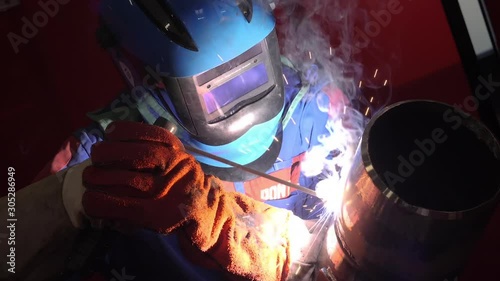 Man welding a pipe in slow motion