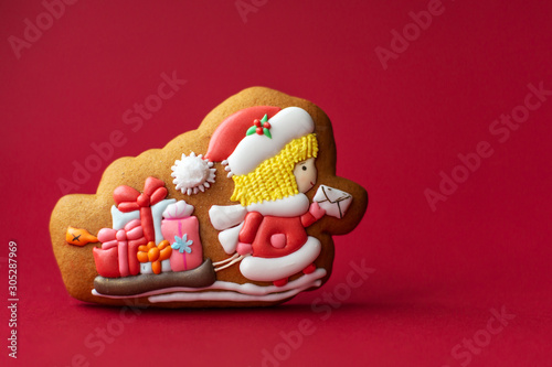 gingerbread cookie of Santa postman on red background. Traditional Christmas food. Christmas and New Year holiday concept.