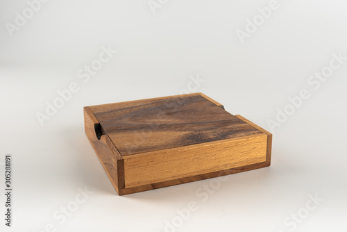 A simple wooden box set on a white background