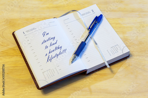The diary is on the table. The diary is open on the first of January page. The page reads: "I'm starting to lead a healthy lifestyle!!!".
