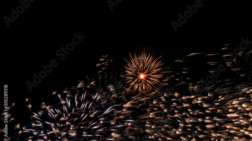 Fotografie A beautiful Fireworks light up the sky with dazzling display on dark background