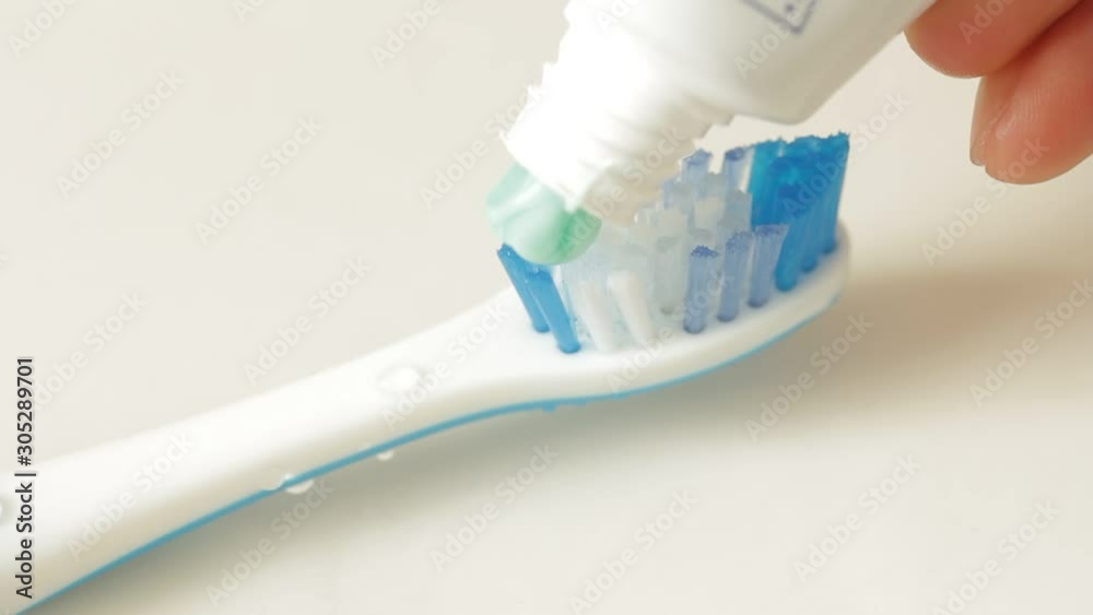 Putting toothpaste on a toothbrush
