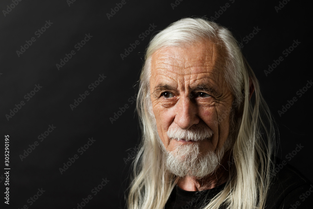 Low key studio portrait of long gray hair old man closeup Low key studio portrait of long gray hair old man closeup