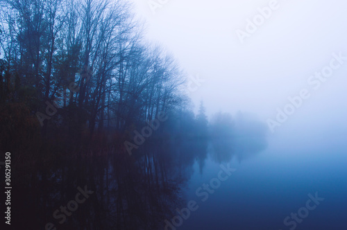 Blue lake in the morning fog