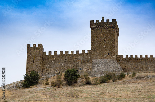 The old fortress. Wall, watchtower of an old fortress in the mountains. Middle Ages. Archeology.