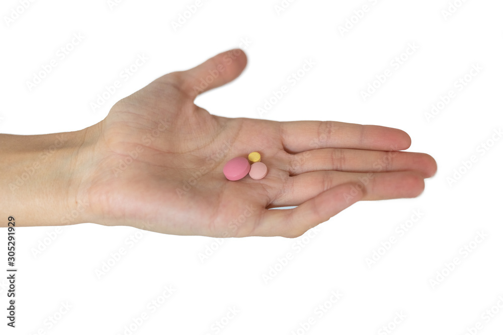 Hand holding pills. Medcine pills. Pills in hand on white background. Close-up shot of a hand with pills. Coronavirus disease.