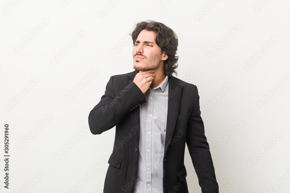 Young business man against a white background suffers pain in throat due a virus or infection. Young business man against a white background suffers pain in throat due a virus or infection.