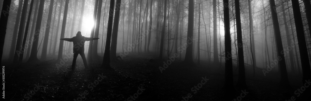 one alone man in a dark foggy forest one alone man in a dark foggy forest