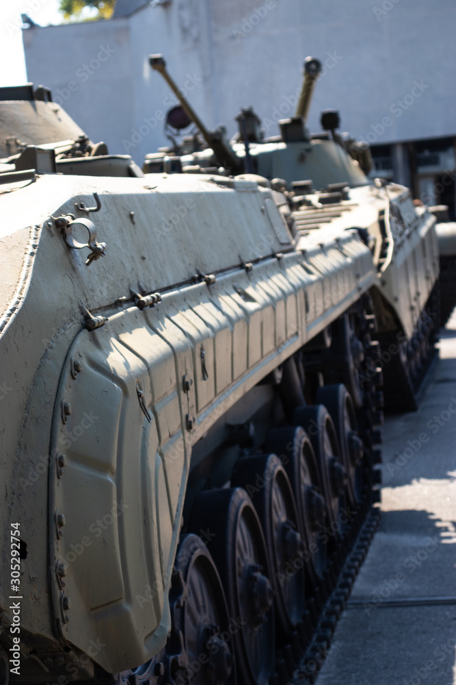 Side of a grey tracked armored vehicle , personnel carrier. Side of a grey tracked armored vehicle , personnel carrier.