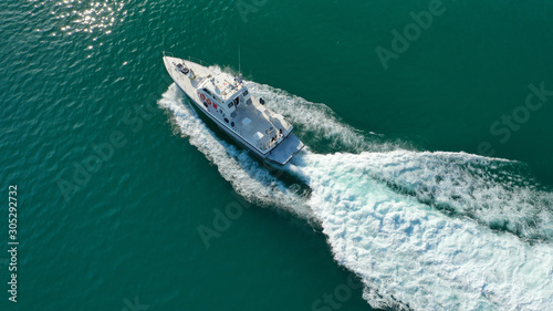 Aerial drone photo of speed boat cruising in high speed in Mediterranean lake with emerald water © aerial-drone
