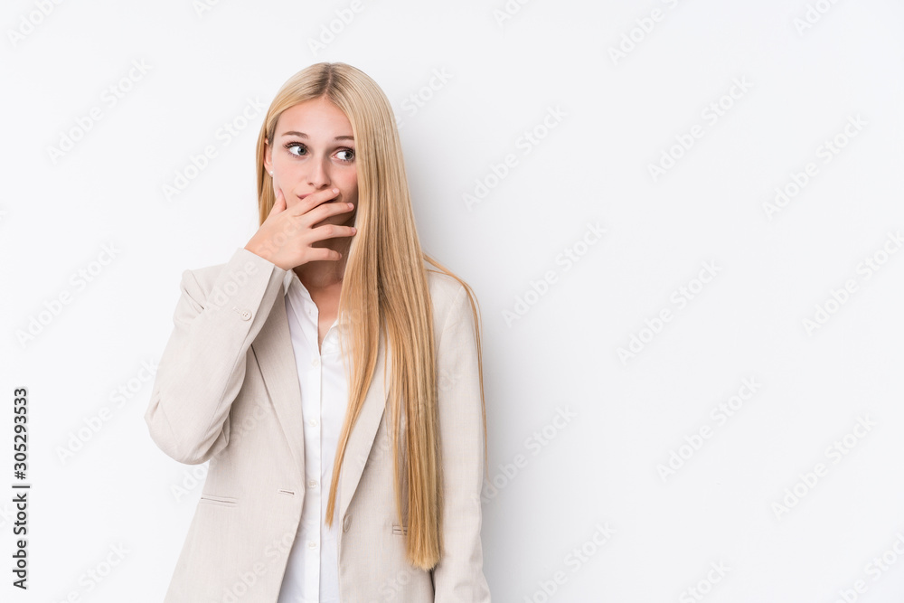 Young business blonde woman on white background thoughtful looking to a copy space covering mouth with hand. Young business blonde woman on white background thoughtful looking to a copy space covering mouth with hand.