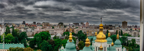 View of rooftops and St.Sophia's church in Kiev on a dark cloudy rainy day