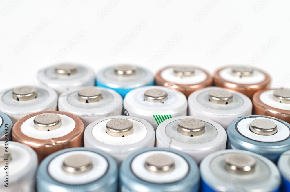 Energy abstract background of colorfu lithium rechargeablel batteries. Close up top view on rows of selection of Ni-MH AA batteries. Several batteries are next to each other. Energy abstract background of colorfu lithium rechargeablel batteries. Close up top view on rows of selection of Ni-MH AA batteries. Several batteries are next to each other.