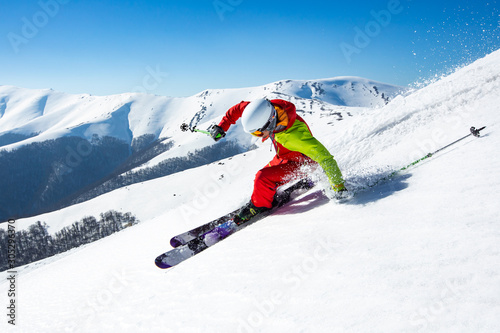 A man is skiing down the hill on the steep slope in Carpathians. Ukraine. High mountain area.