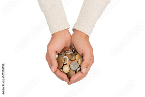 Female hands full of various coins.