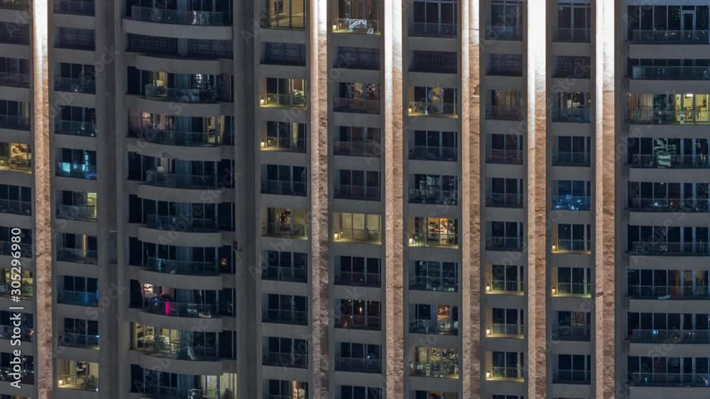 Night view of apartment building timelapse. High rise skyscraper with blinking windows with people moving inside. Aerial view from above. Zoom in Night view of apartment building timelapse. High rise skyscraper with blinking windows with people moving inside. Aerial view from above. Zoom in