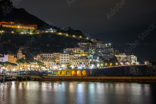 Night view of Amalfi cityscape on coast of mediterranean sea, Italy.