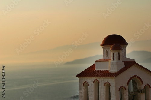 sunset in greece with ocean and greek islands and chrurch