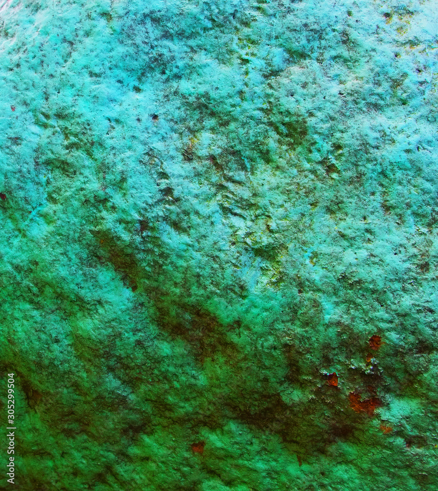 Old painted granite stone rock background. Green, cyan, turquoise, aquamarine.