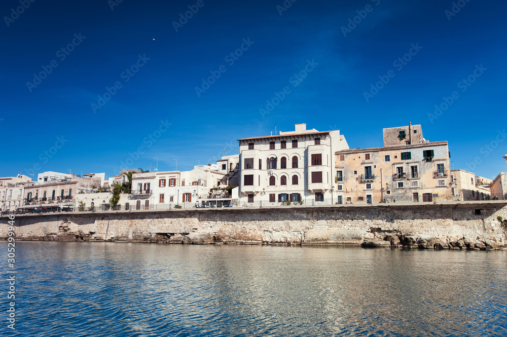 Cityscape of ancient buildings in seafront of Ortygia. Syracuse. Italy