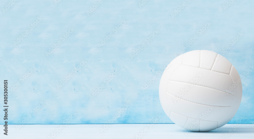 Volleyball court wooden floor with ball on blue with copy-space