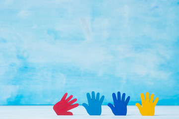 Colorfull puzzles hands on blue background. World Autism Awareness Day Concept