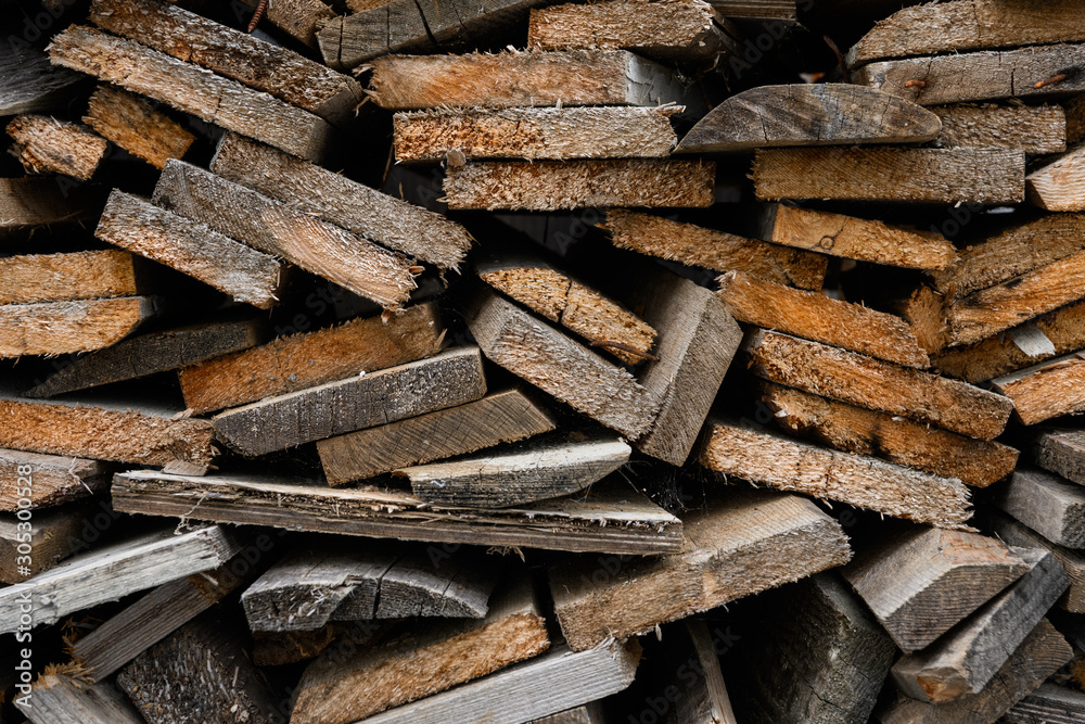 Piles of old wooden boards in the sawmill, planking. Wood timber stack of wooden blanks construction material. Industry. Piles of old wooden boards in the sawmill, planking. Wood timber stack of wooden blanks construction material. Industry.