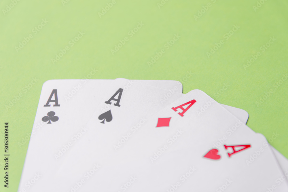 Obraz premium Four aces on green background. Concept of gambling risk